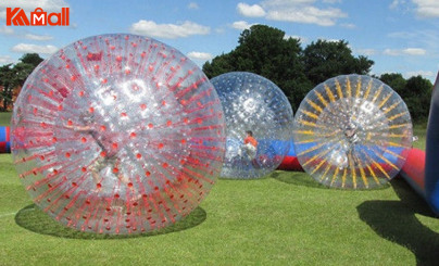 kids zorb ball in the grass